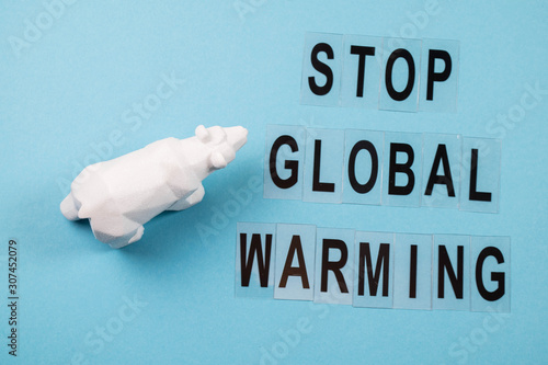 Toy polar bear struggling showing impact on climate of the polar bear due to global warming