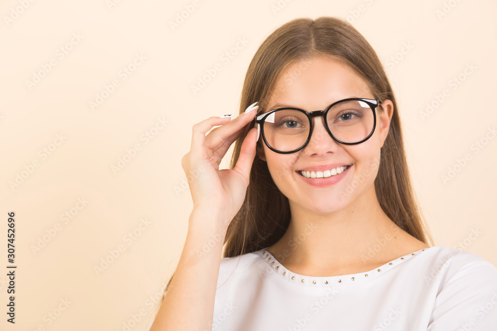beautiful young woman in glasses on a beige background beautiful young woman in glasses on a beige background