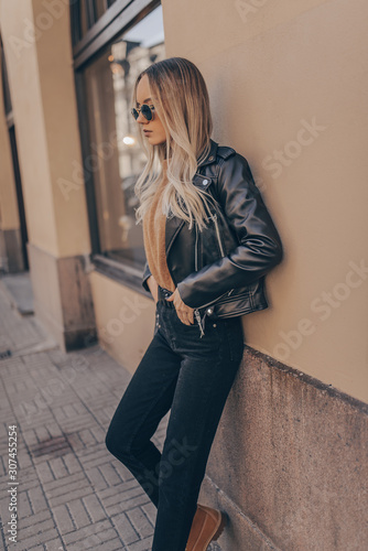 Stylish woman in jacket posing in outdoor photo