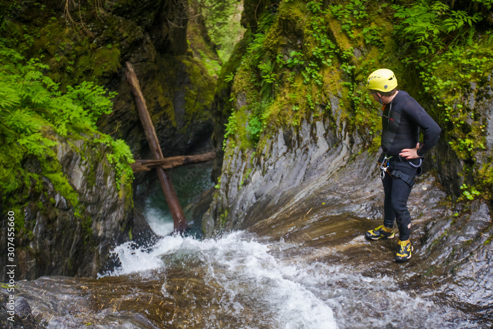 High angle of a man looking over the edge of a waterfall High angle of a man looking over the edge of a waterfall