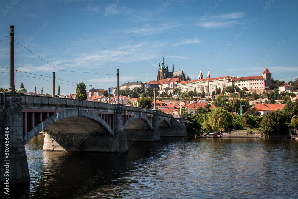 View of the city of Prague with a bridge in the foreground and the castle in the background
