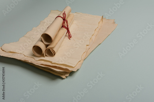 Raven feather, inkwell and old yellowed paper on red background. Copy space.