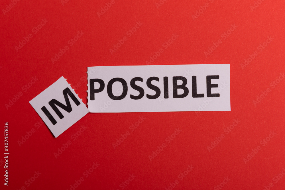 Impossible text cut out. Possible concept. Success. Pink background. Copy space. Vertical orientation. View from above. Minimal simple style. Impossible text cut out. Possible concept. Success. Pink background. Copy space. Vertical orientation. View from above. Minimal simple style.