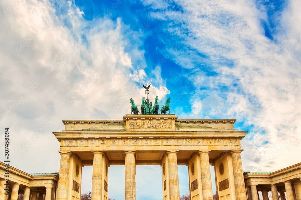 Brandenburg Gate Brandenburger Tor details in Berlin, Germany during bright day with a blue sky. Famous landmark in Berlin.