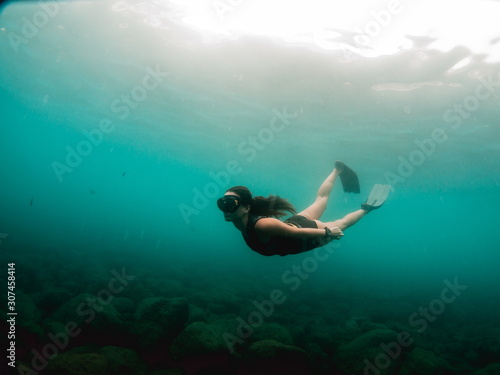 Young woman doing freedive in the Mediterranean sea photo