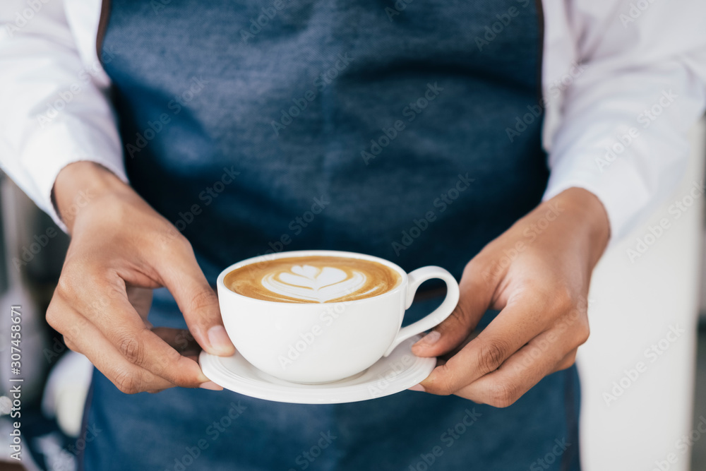 Young owner of coffee cafe service customer. Young owner of coffee cafe service customer.