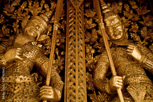 Traditional guardians in the Temple of the Emerald Buddha photo