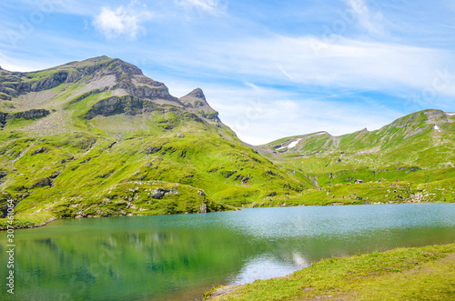 Beautiful Bachalpsee lake in the Swiss Alps in the summer season. Alpine lake and landscape. Popular hiking target on the path from Grindelwald. Tourist attraction in Switzerland