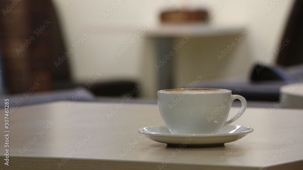 cup of coffee on beige table cup of coffee on beige table