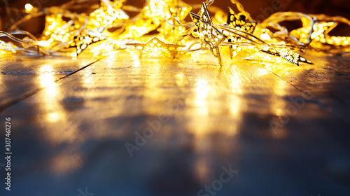 Blurred Background. Yellow or warm white color christmas lights on floor