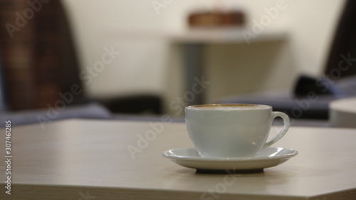 cup of coffee on beige table