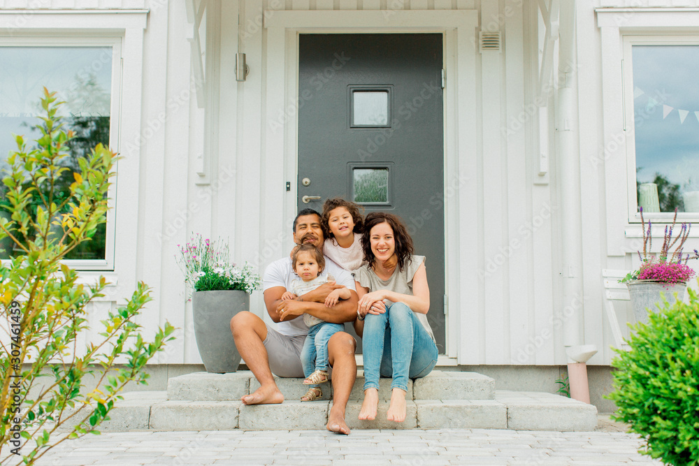 Family sitting on front stoop Family sitting on front stoop