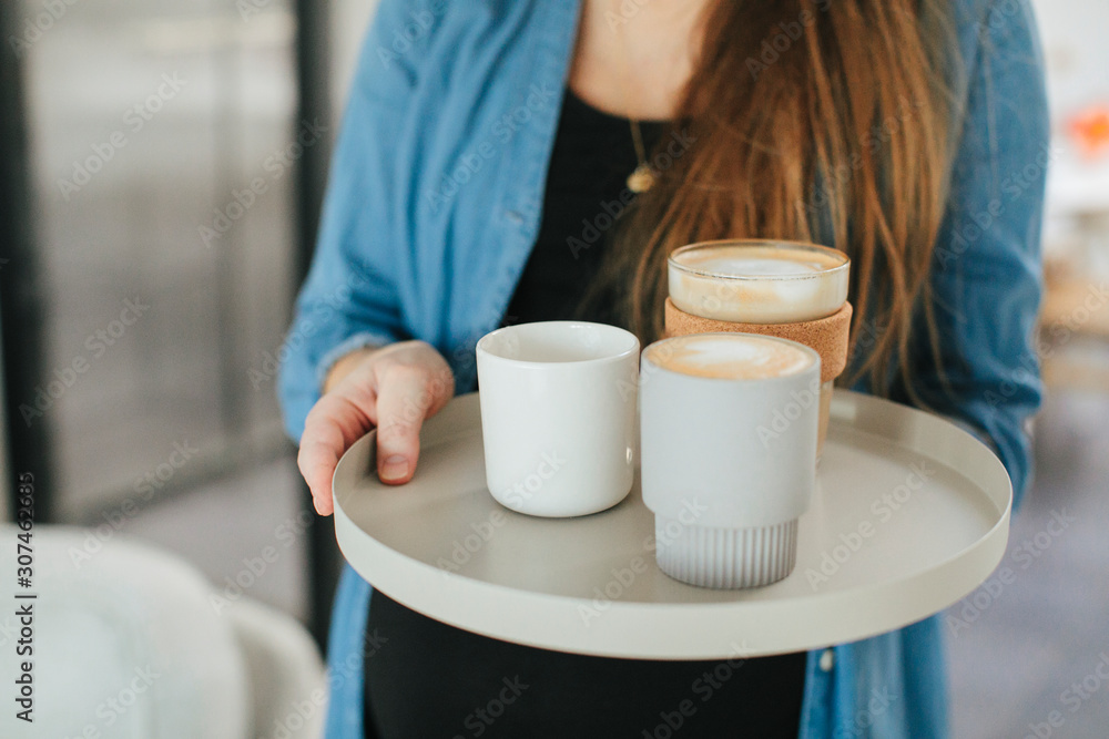 Woman with coffees on tray Woman with coffees on tray