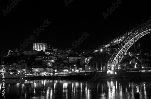 Night view in black in white of the Dom Luis I bridge from the Villa Nova de Gaia dock
