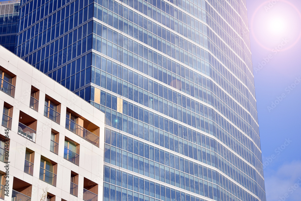 Modern office building detail, glass surface with sunlight. Business background. Modern office building detail, glass surface with sunlight. Business background.