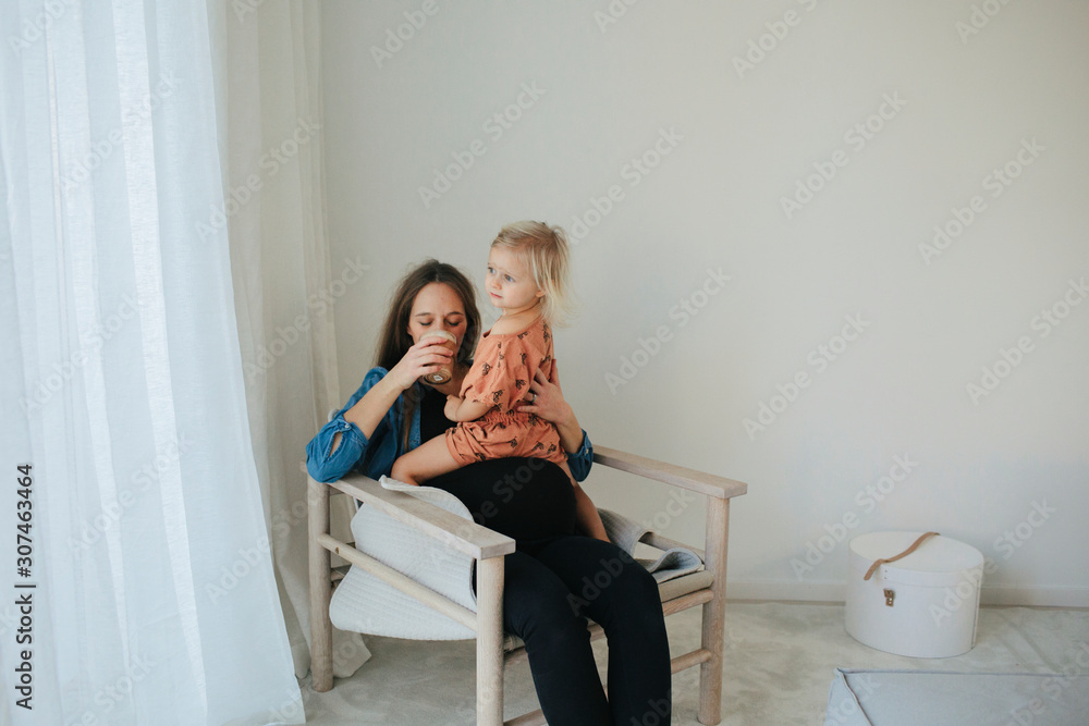 Mother and daughter sitting together Mother and daughter sitting together