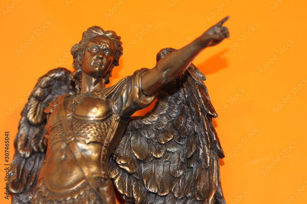 Fototapeta premium bronze sculpture of Archangel Michael with wings and sword