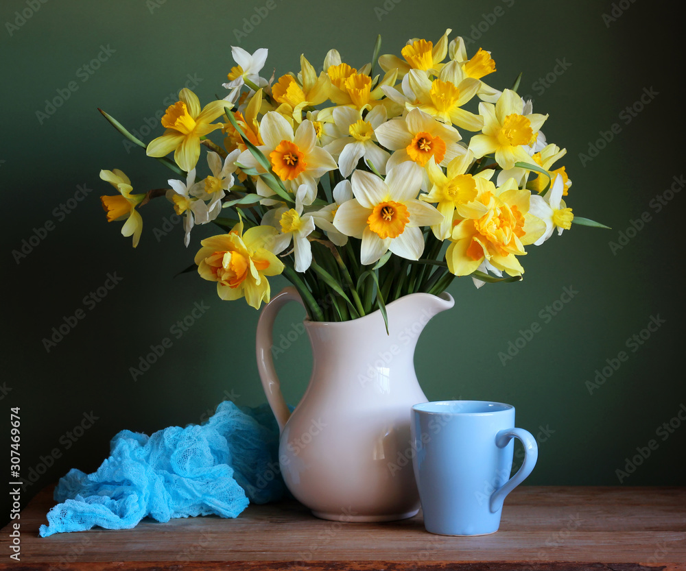 white and yellow daffodils in a jug.