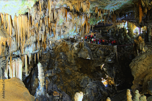 Amazing landscape view of Postojna Cave. Ancient formations inside cave with stalactites and stalagmites. Famous touristic place and travel destination in Europe. Slovenia
