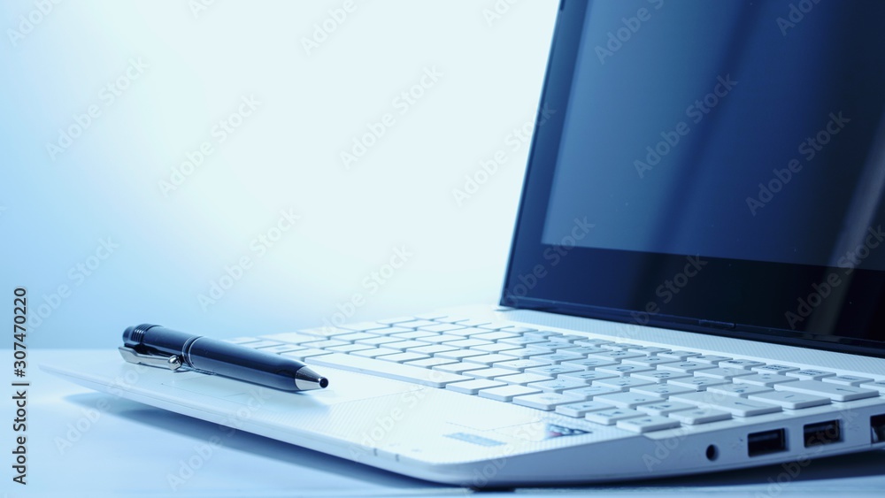 Open notebook and black pen on a white background. Back light. Business concept Open notebook and black pen on a white background. Back light. Business concept
