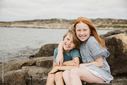 Brother and sister playing at seaside photo