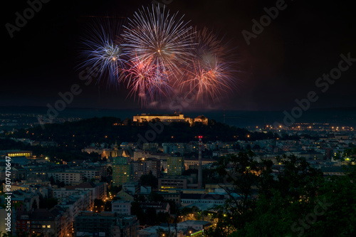 Fireworks Brno city night view with buildings and dark sky. Pyrotechnics festival in Czech republic, beautiful show.
