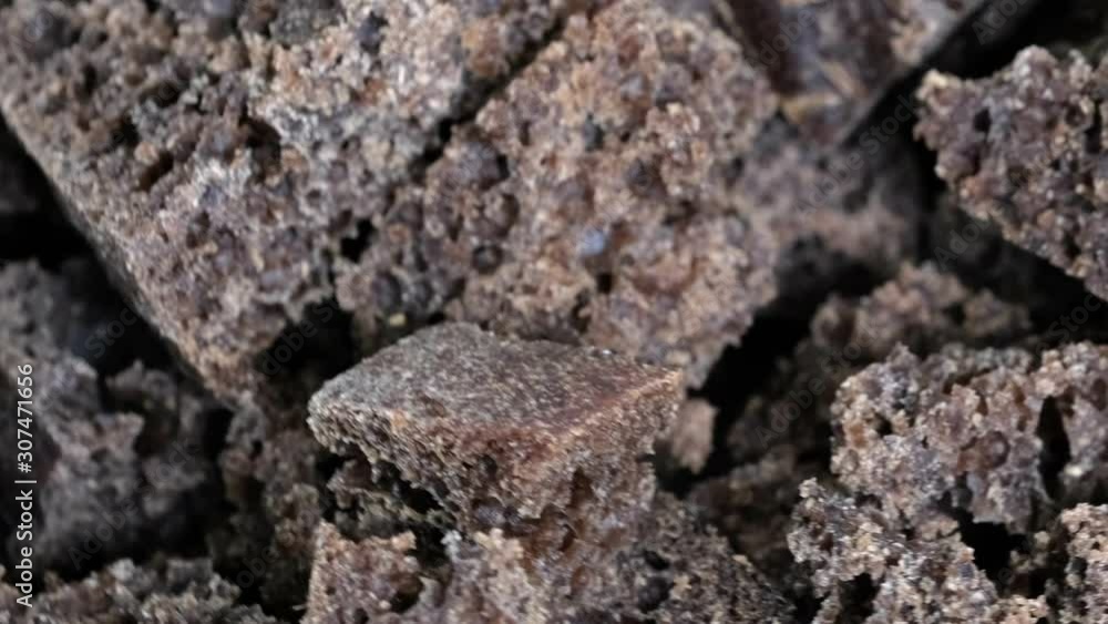Grocery video screensaver, rotating background from small pieces of black rye bread macro close-up top view using zoom and move the camera Grocery video screensaver, rotating background from small pieces of black rye bread macro close-up top view using zoom and move the camera