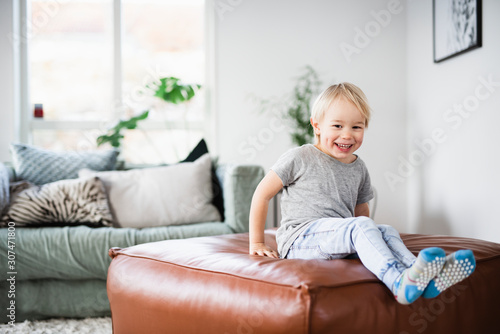 Boy playing on sofa photo