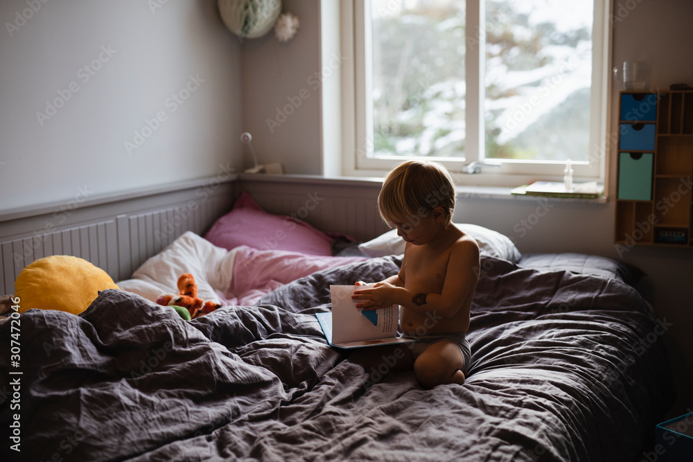 Boy reading on bed Boy reading on bed