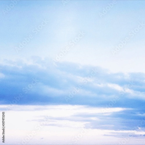 Blue sky and white clouds. View from below. Square shot.