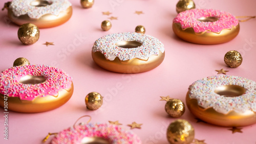 Wallpaper Mural Christmas toys in the form of donuts on a pink background with gold decor, selective focus, side view. Creative food minimalism Torontodigital.ca