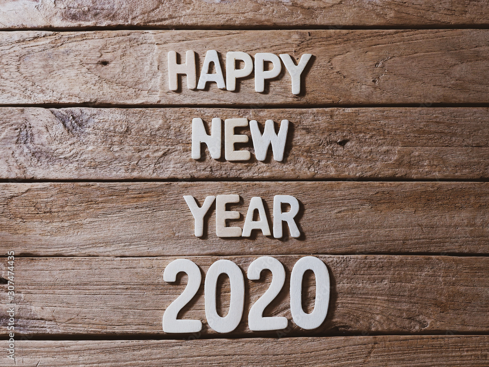 happy new year 2020 alphabet on old wood background