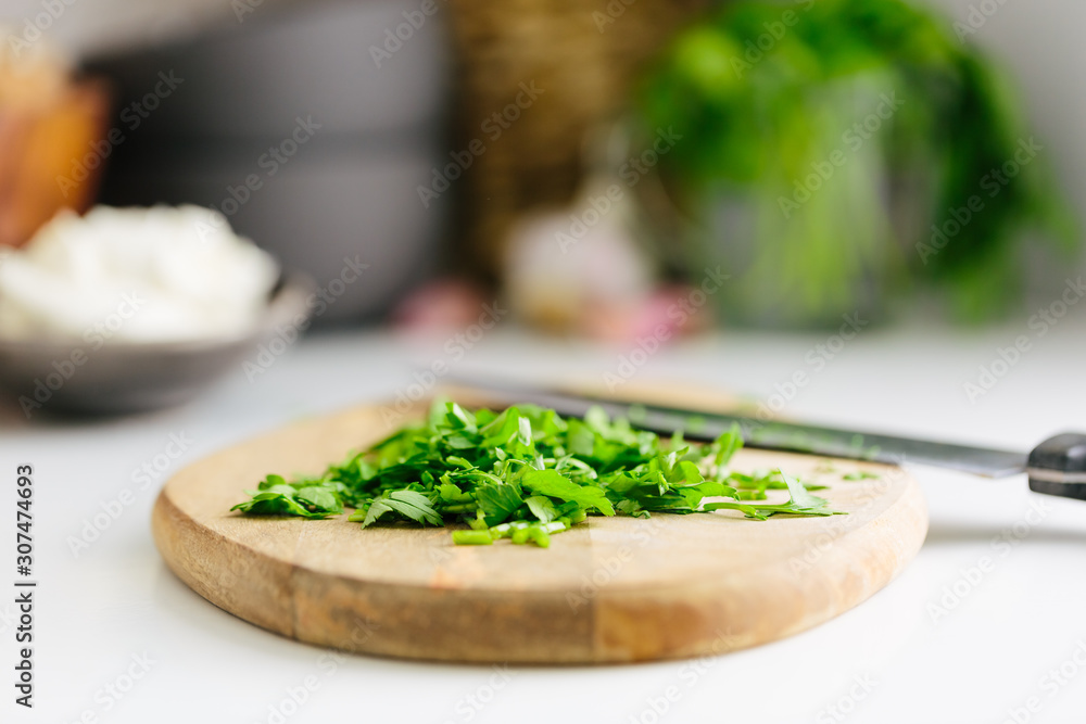 Parsley chopped on board on kitchen counter Parsley chopped on board on kitchen counter