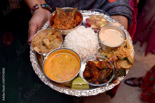 Newly married husband and wife exchanging Traditional Indian food Thali after marriage , A traditional Bengali wedding rituals in West Bengal or Bangladesh.