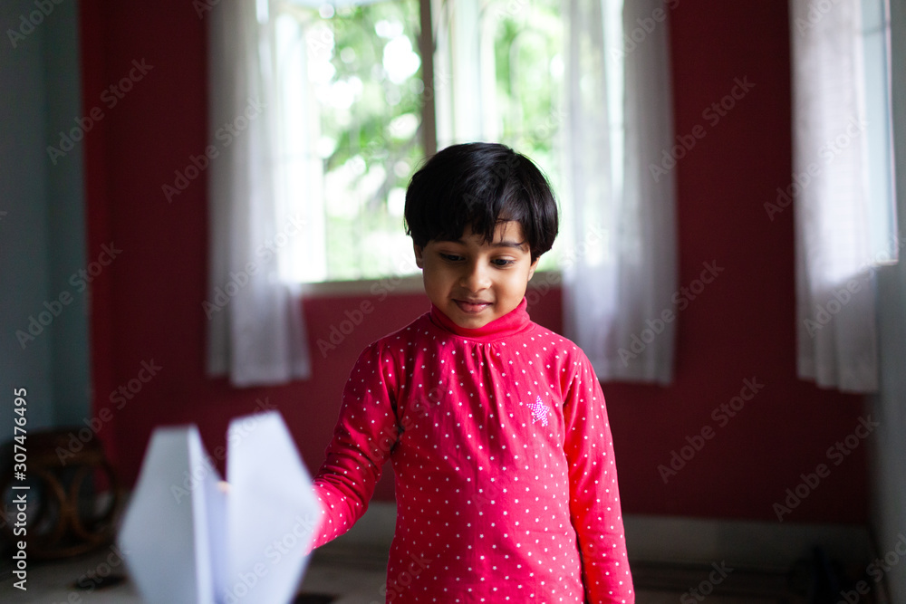 Little girl playing with paper plane Little girl playing with paper plane