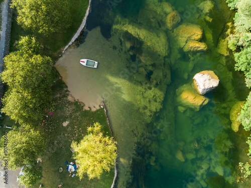 Aerial view of small boat anchored at Cetina river, Blato Na Cetini, Croatia. photo