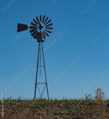 Metal windmill in farm country