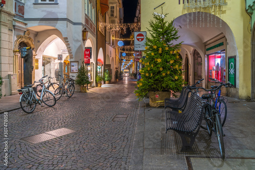 Fototapeta Naklejka Na Ścianę i Meble -  Bolzano, Italy 01 December 2019: Christmas decor on the night streets of Bolzano in South Tyrol.