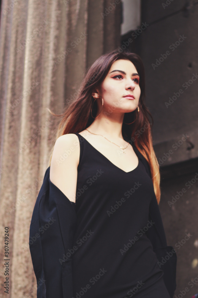 Fototapeta premium Model in black dress and long jacket. Style. Fashion trends 2020. Hair with ombre. Business lady. Blogger. Work