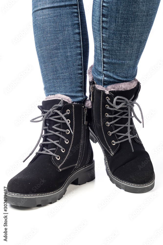 demi-season women's boots black on the feet in jeans on a white background