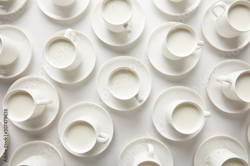 Layout of white cups with milk photo