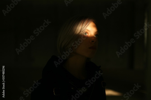 portrait of a girl in a ray of light photo