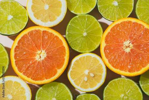 Close up of half tangerine, lemon and lime photo