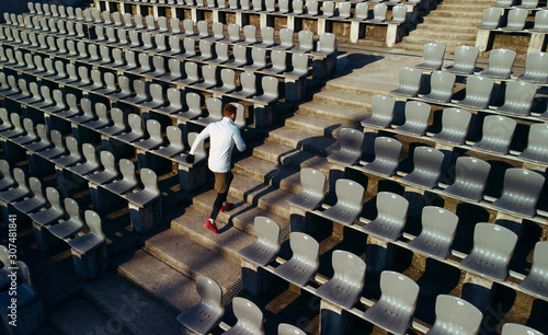 Sportsman running up stadium steps photo