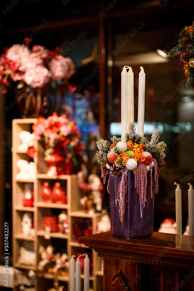 Beautiful vase is decorated with New Year decorations, candles for the New Year holiday