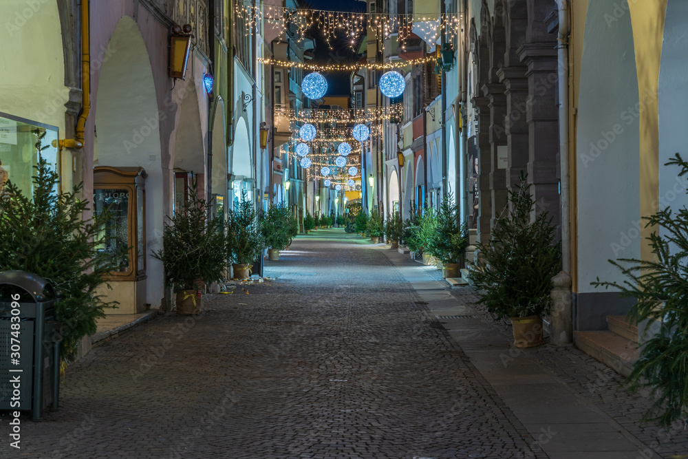Bolzano, Italy 01 December 2019: Christmas decor on the night streets of Bolzano in South Tyrol.
