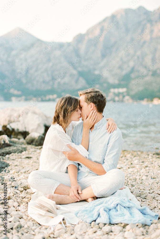 young couple kissing on the seashore young couple kissing on the seashore