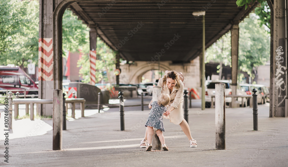 Mother and daughter on a walk through the city Mother and daughter on a walk through the city