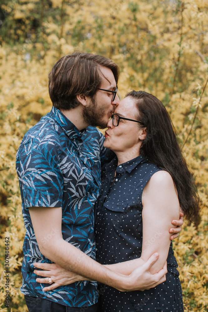 Adult Son Kissing Mother on Forehead Adult Son Kissing Mother on Forehead