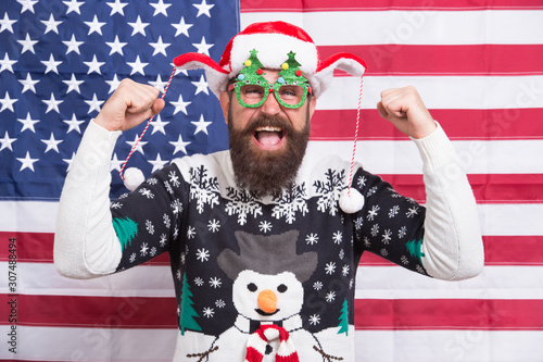 Hooray. All american xmas party. Christmas in usa. Santa on american flag background. Bearded american man celebrate new year. National us flag. Patriotic hipster celebrate winter holidays © be free